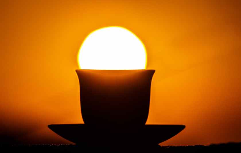 silhouette of teacup on saucer during sunset